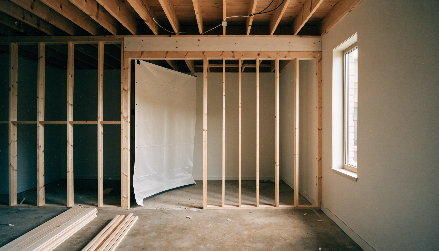 Golf simulator bay part way through construction, framing exposed on one side