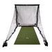 Golf practice net with green mat and golf balls on a white background