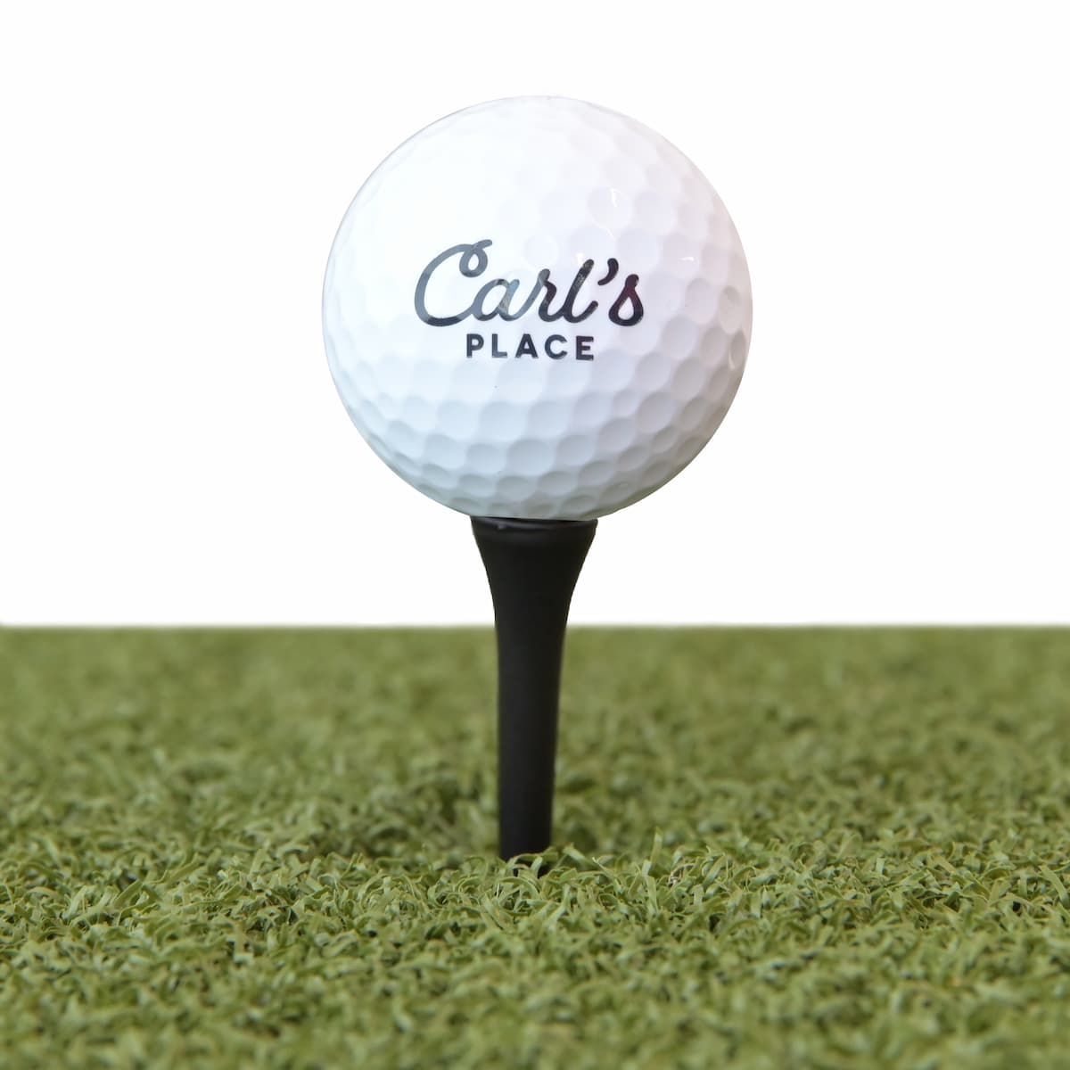 Carl's driver height golf tees on a hitting mat
