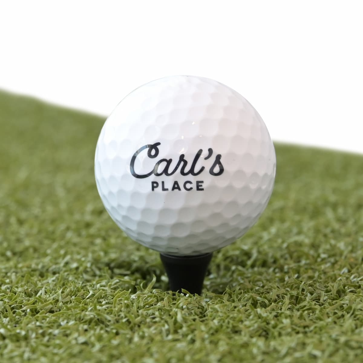 Carl's iron height golf tees on a hitting mat