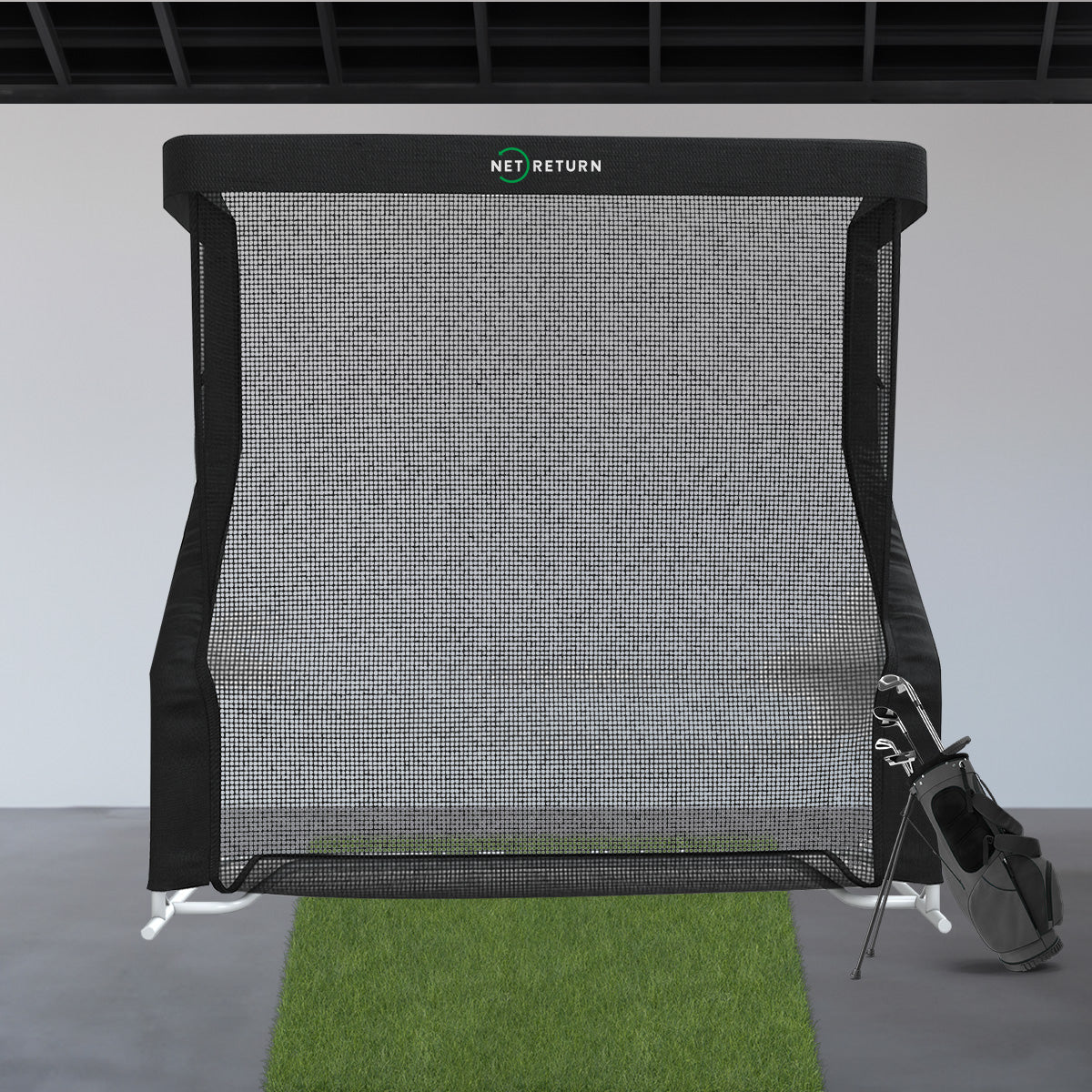 Golf practice net with a golf club on a gray floor and white wall background
