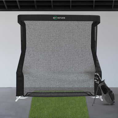 Golf practice net with a golf club on a gray floor and white wall background
